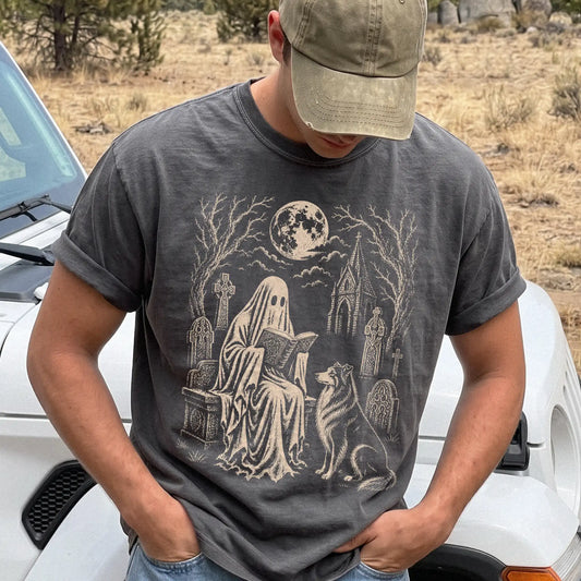 Model wearing a Pepper Comfort Colors® T-shirt showing Collie beside a reading ghost in a moonlit graveyard
