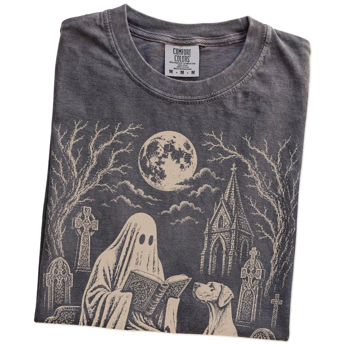 Folded Pepper Comfort Colors® T-shirt showing Great Dane beside a reading ghost in a moonlit graveyard