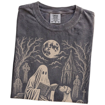 Folded Pepper Comfort Colors® T-shirt showing Great Dane beside a reading ghost in a moonlit graveyard