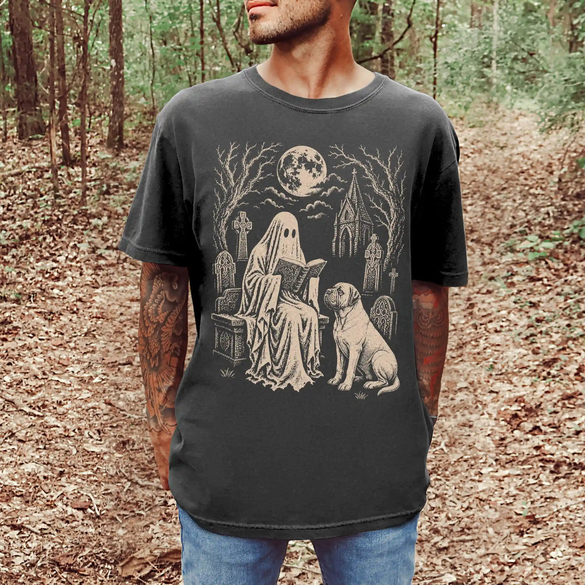 Model wearing a Pepper Comfort Colors® T-shirt showing Mastiff beside a reading ghost in a moonlit graveyard