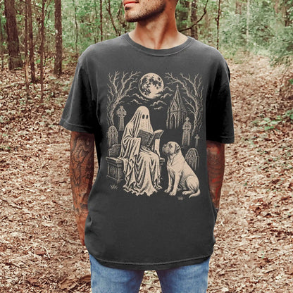 Model wearing a Pepper Comfort Colors® T-shirt showing Mastiff beside a reading ghost in a moonlit graveyard
