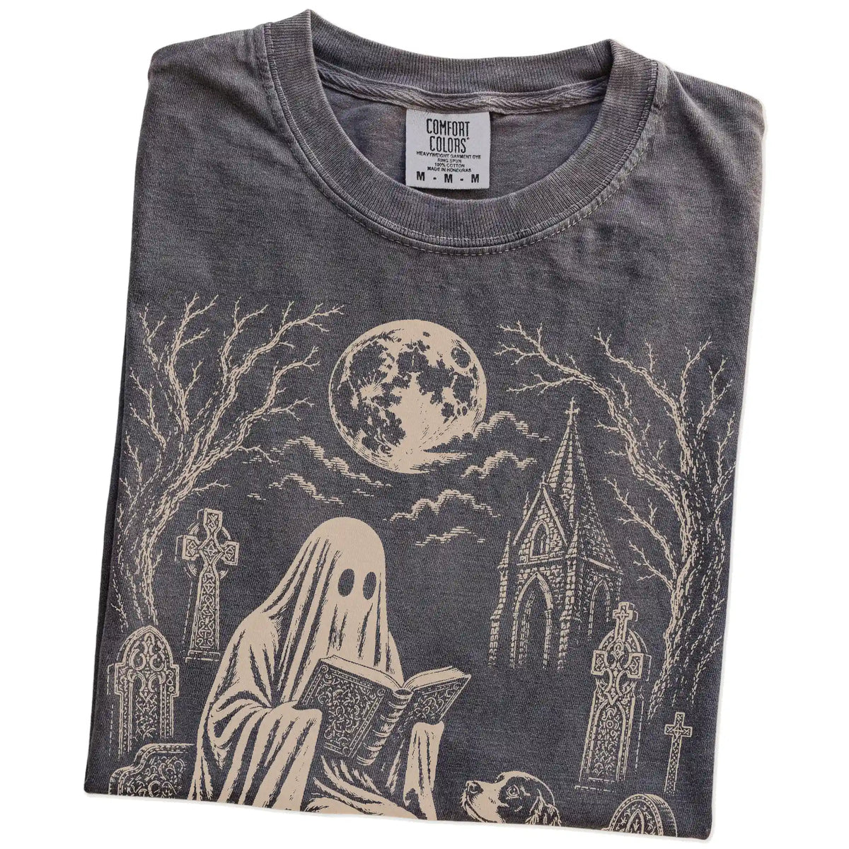 Folded Pepper Comfort Colors® T-shirt showing Springer Spaniel beside a reading ghost in a moonlit graveyard