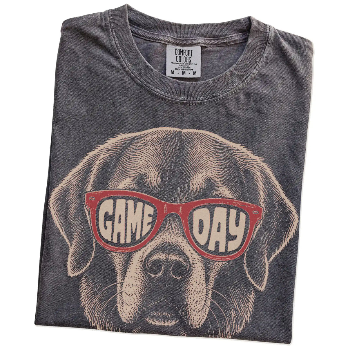 Folded Pepper Comfort Colors® T-shirt showing golden retriever wearing red game day sunglasses
