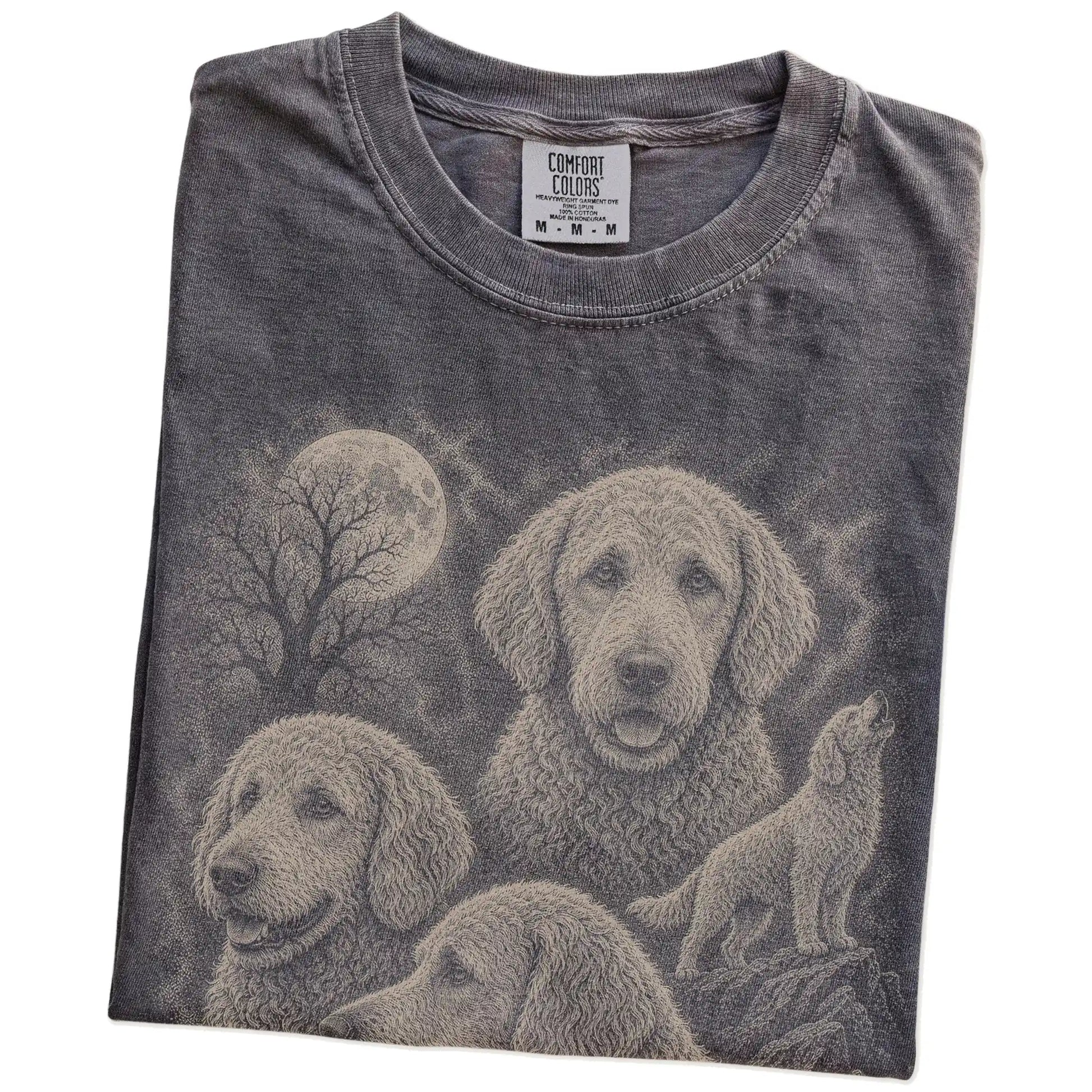 Folded Pepper Comfort Colors® T-shirt showing a vintage moon montage featuring Goldendoodle