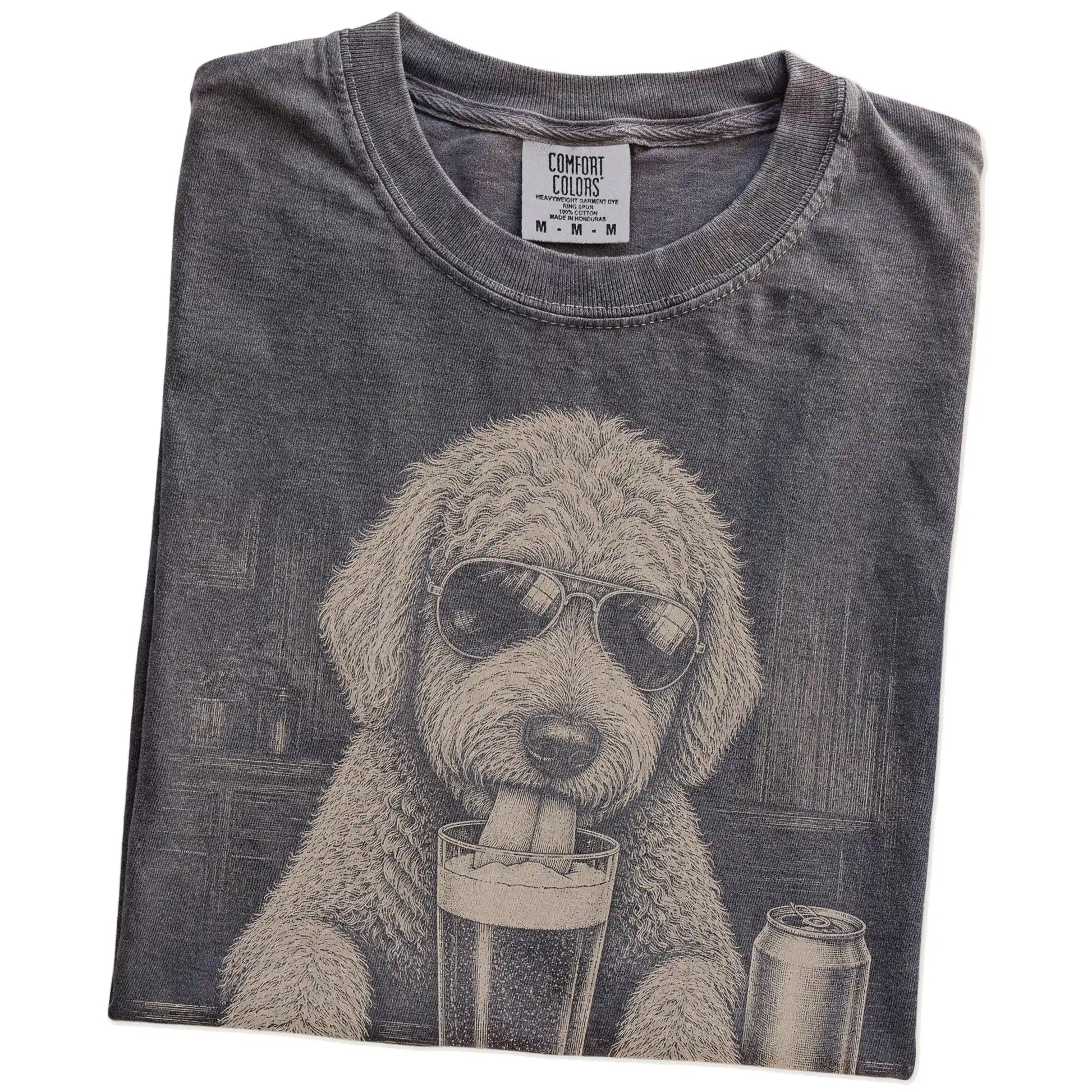 Folded Pepper Comfort Colors® t-shirt showing Goldendoodle sneaking a drink from a pint