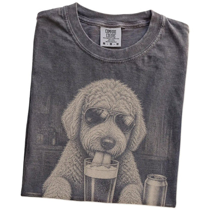 Folded Pepper Comfort Colors® t-shirt showing Goldendoodle sneaking a drink from a pint