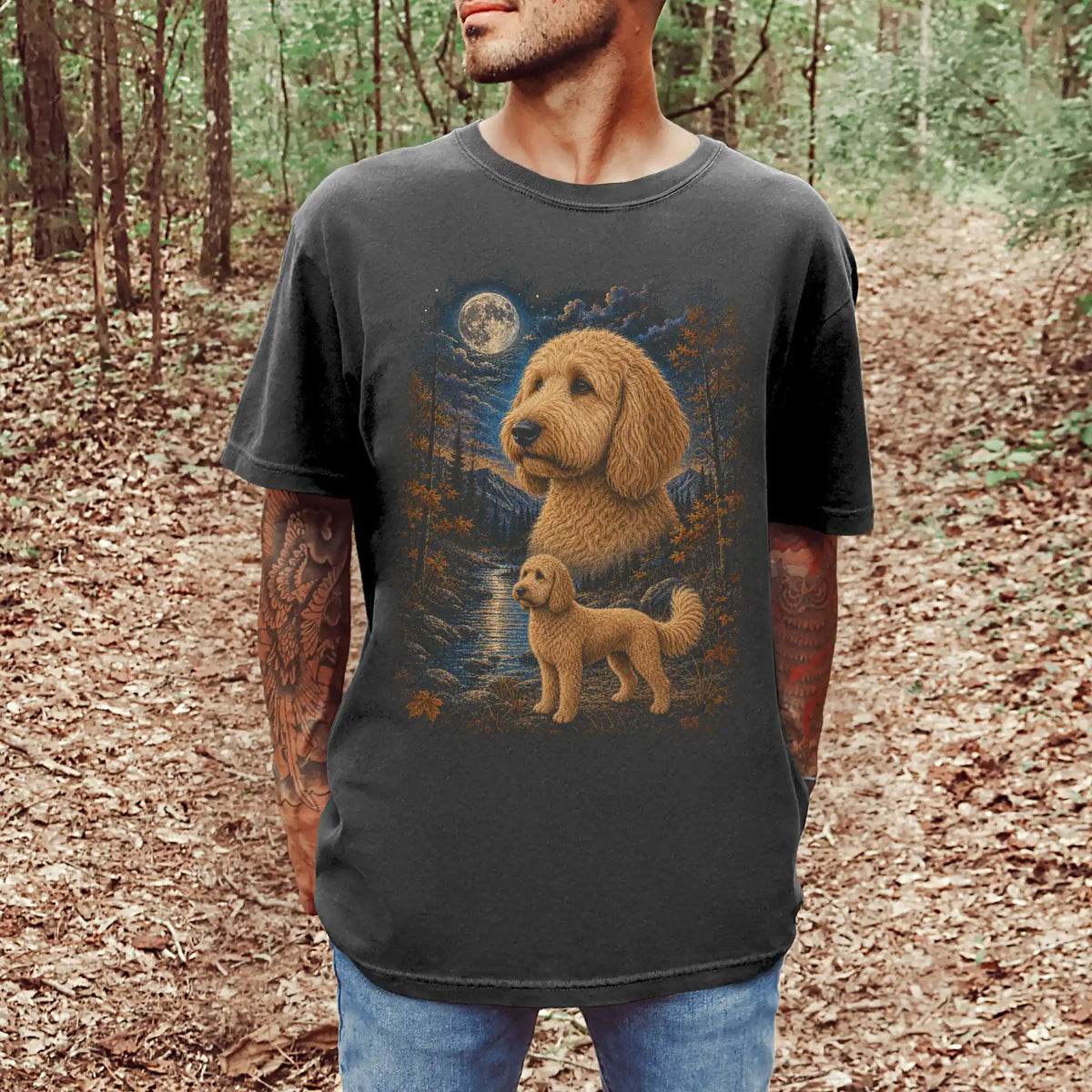 Model wearing a Pepper Comfort Colors® t-shirt featuring Goldendoodle in a moonlit fall forest