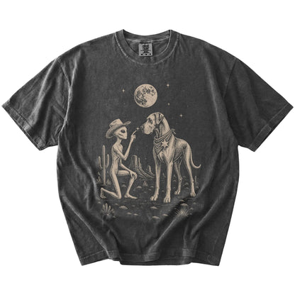 Cowboy alien fist-bumping a Great Dane beneath the moon on a Pepper Comfort Colors® T-shirt
