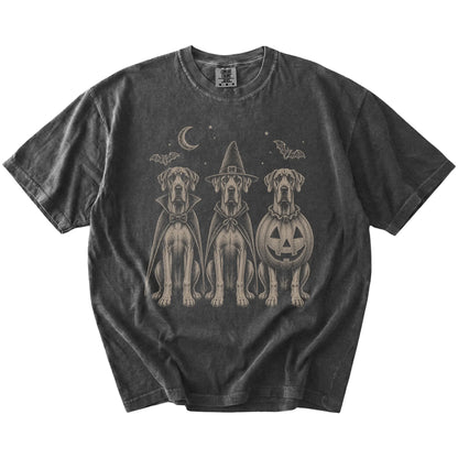 Three Great Dane dogs dressed for Halloween beneath bats and a crescent moon on a Pepper Comfort Colors® T-shirt