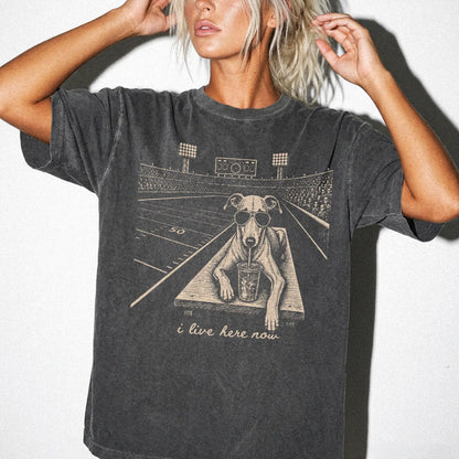 Model wearing a Pepper Comfort Colors® T-shirt featuring Greyhound ready for football and tailgate season