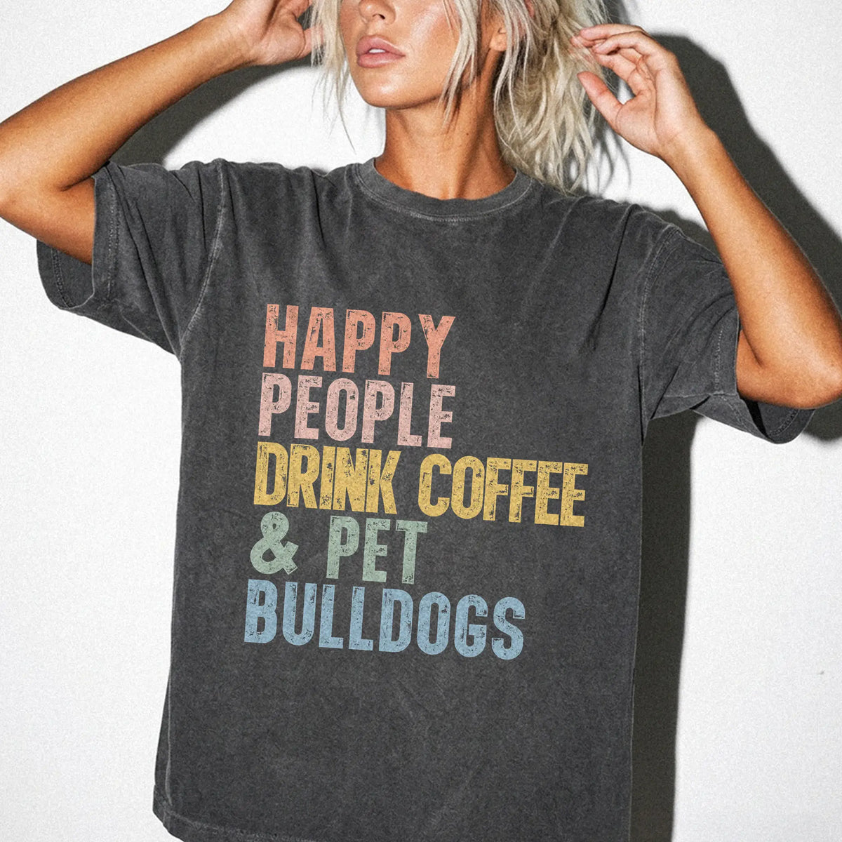 Model wearing a Pepper Comfort Colors® T-shirt featuring Bulldog with coffee and “Happy People Drink Coffee and Pet Dogs” let