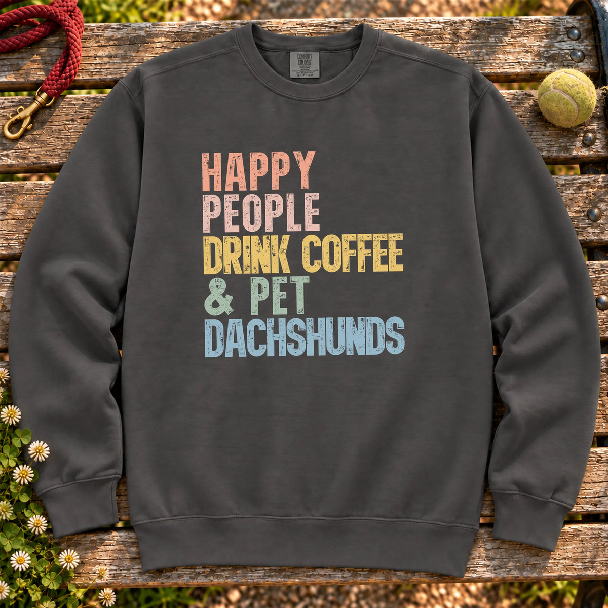 “Happy people drink coffee & pet Dachshunds” text on a Pepper sweatshirt