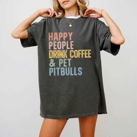 Model wearing a Pepper Comfort Colors® T-shirt featuring Pitbull with coffee and “Happy People Drink Coffee and Pet Dogs” let