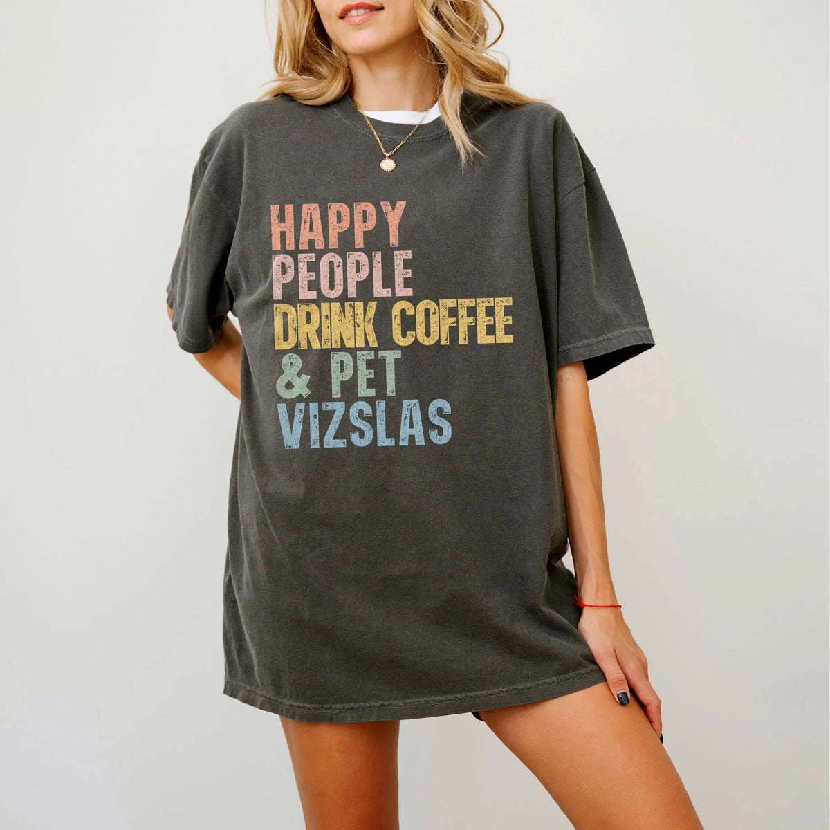 Model wearing a Pepper Comfort Colors® T-shirt featuring Vizsla with coffee and “Happy People Drink Coffee and Pet Dogs” lett