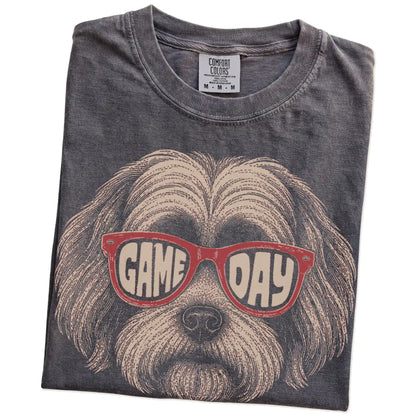 Folded Pepper Comfort Colors® T-shirt showing havanese wearing red game day sunglasses