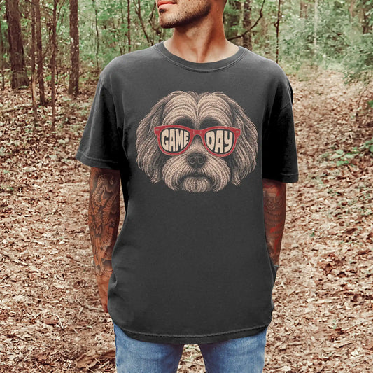 Model wearing a Pepper Comfort Colors® T-shirt with havanese wearing red game day sunglasses
