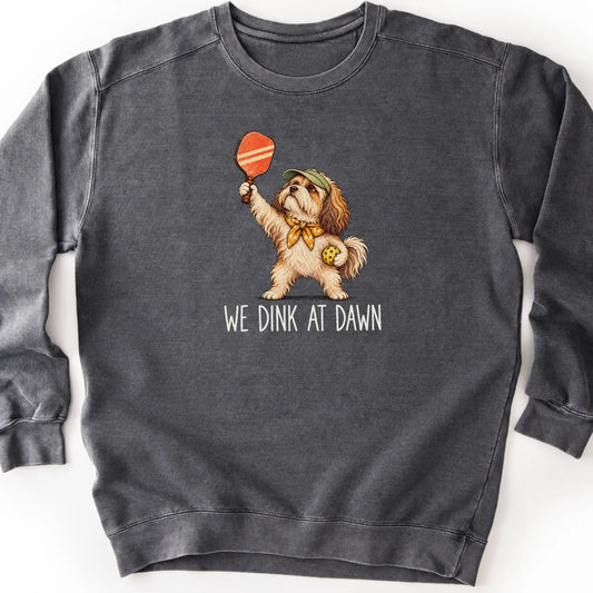 Havanese with a pickleball paddle and ball on a Pepper Comfort Colors® sweatshirt with We Dink at Dawn text