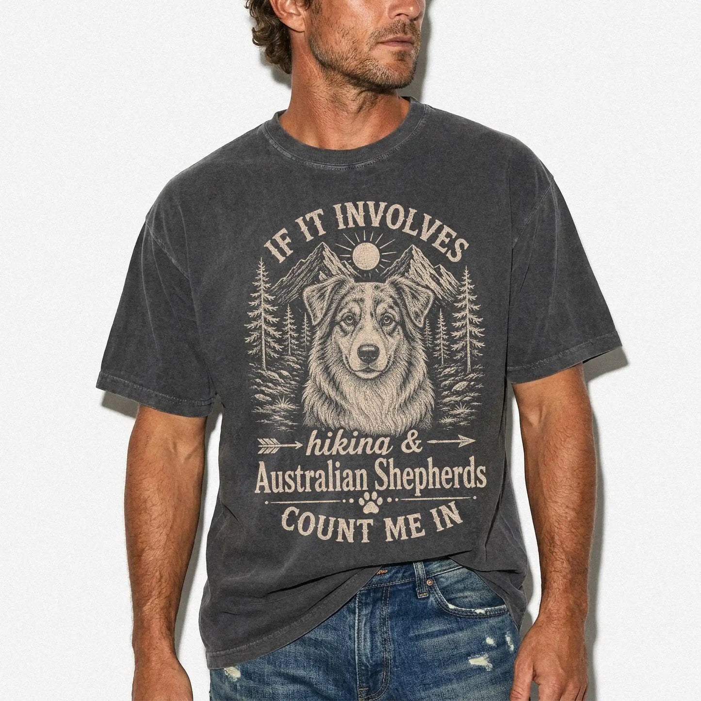 Model wearing a Pepper Comfort Colors® T-shirt featuring Australian Shepherd hiking design with mountain scenery