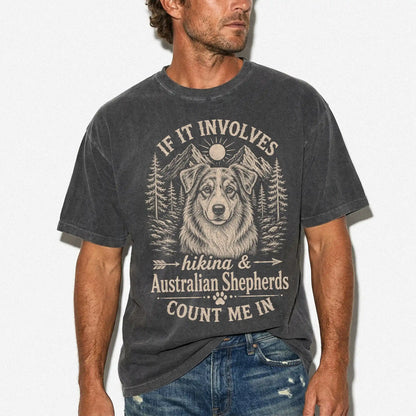 Model wearing a Pepper Comfort Colors® T-shirt featuring Australian Shepherd hiking design with mountain scenery