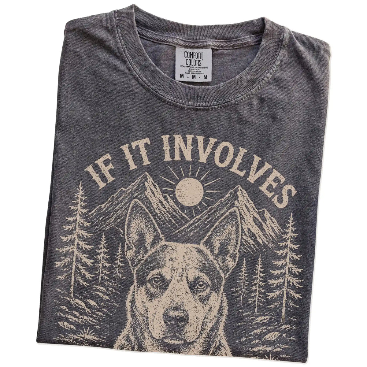 Folded Pepper Comfort Colors® T-shirt showing Blue Heeler hiking design with mountain scenery