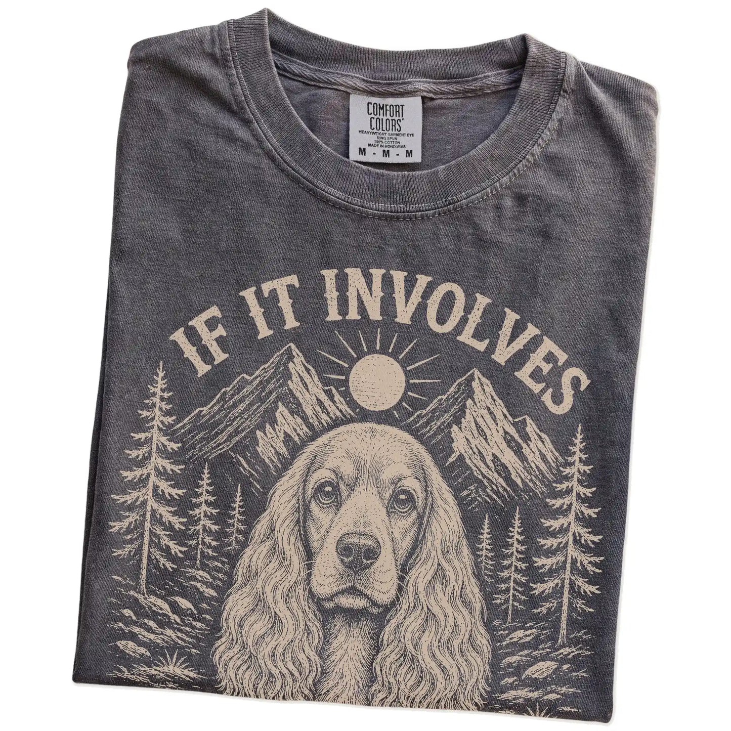 Folded Pepper Comfort Colors® T-shirt showing Cocker Spaniel hiking design with mountain scenery