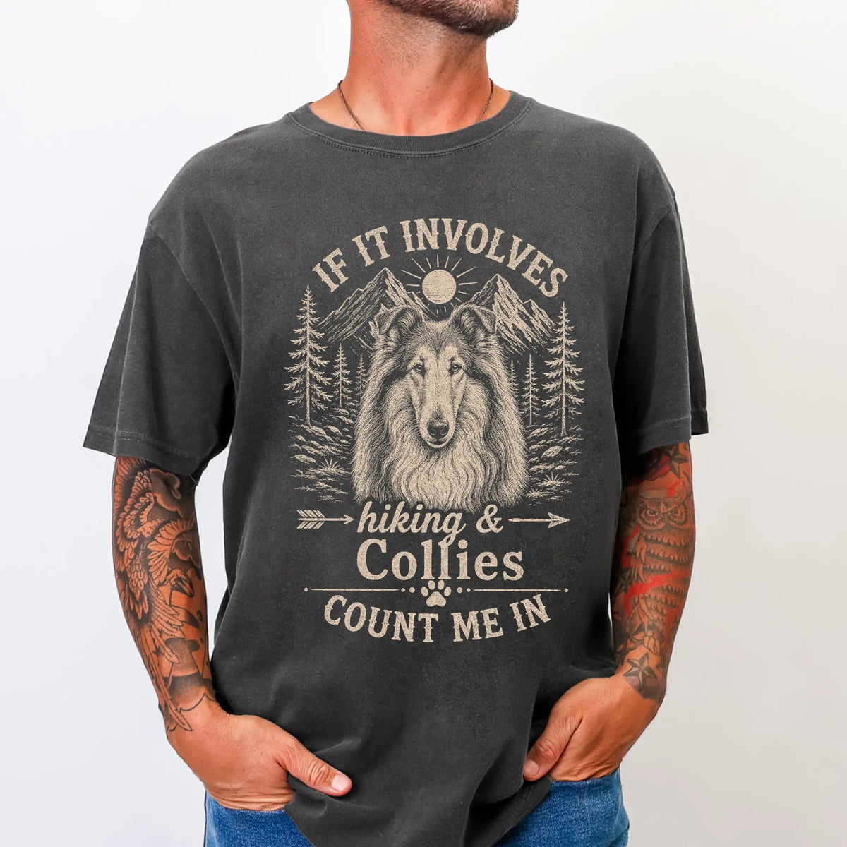 Model wearing a Pepper Comfort Colors® T-shirt featuring Collie hiking design with mountain scenery