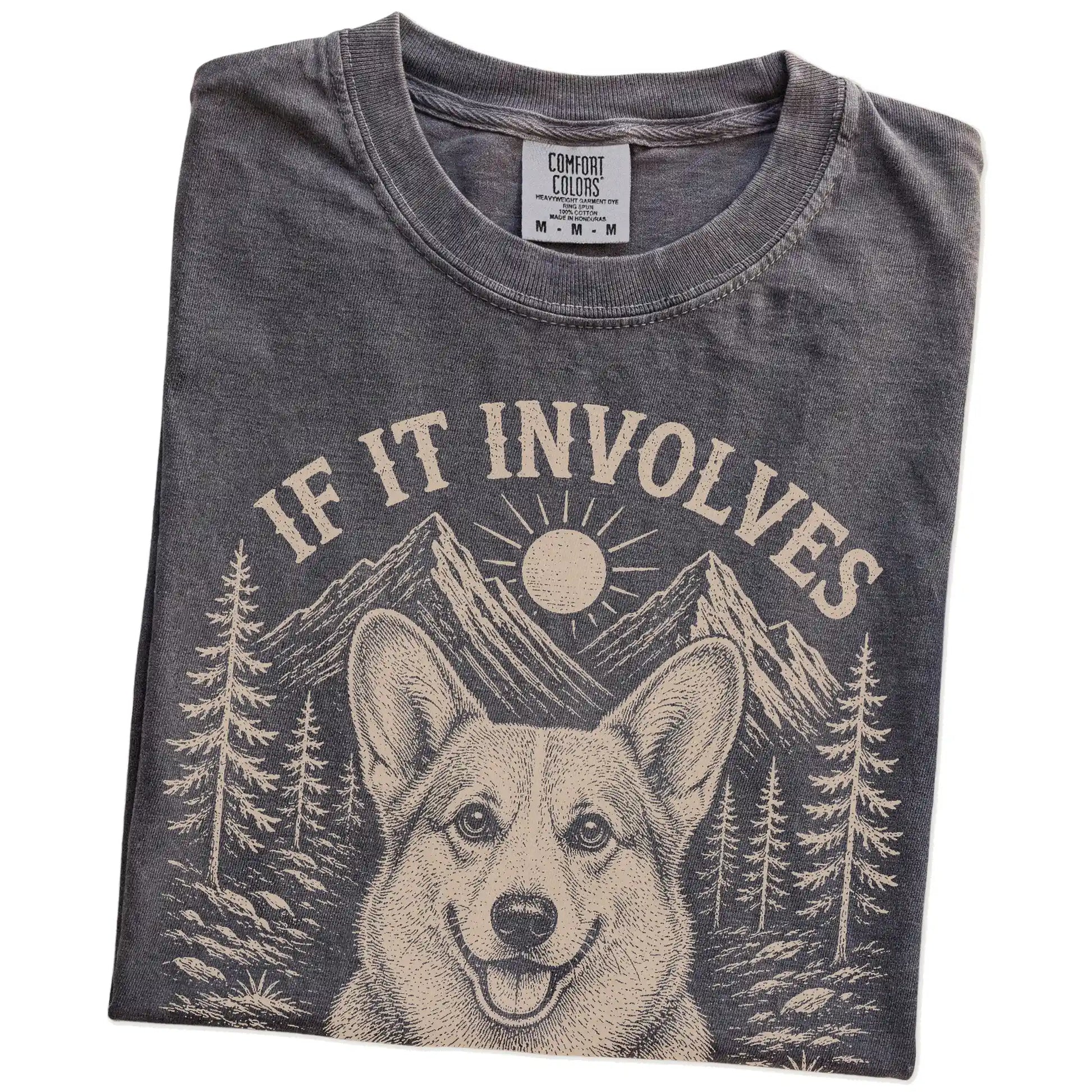 Folded Pepper Comfort Colors® T-shirt showing Corgi hiking design with mountain scenery