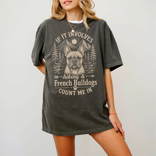 Model wearing a Pepper Comfort Colors® T-shirt featuring French Bulldog hiking design with mountain scenery