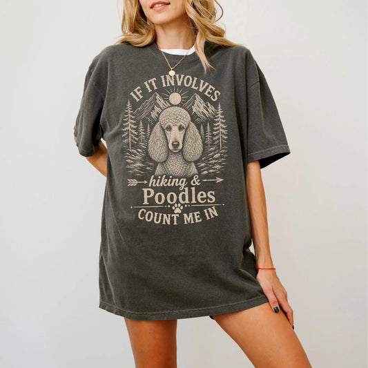 Model wearing a Pepper Comfort Colors® T-shirt featuring Poodle hiking design with mountain scenery