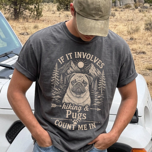 Model wearing a Pepper Comfort Colors® T-shirt featuring Pug hiking design with mountain scenery
