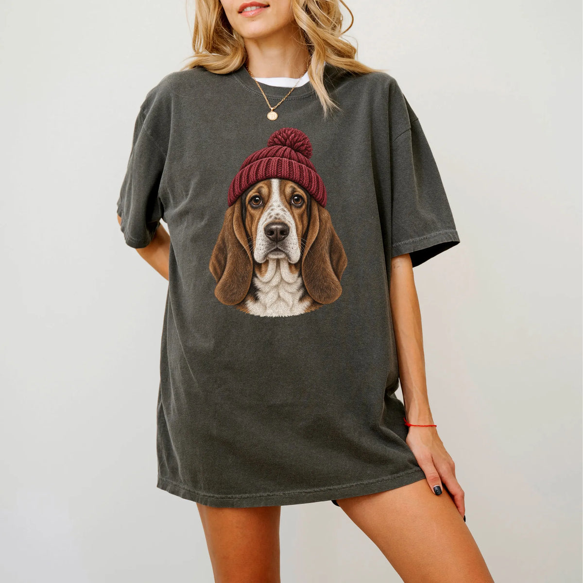 Woman wearing a Pepper Basset Hound hipster T-shirt with a maroon-beanie dog portrait