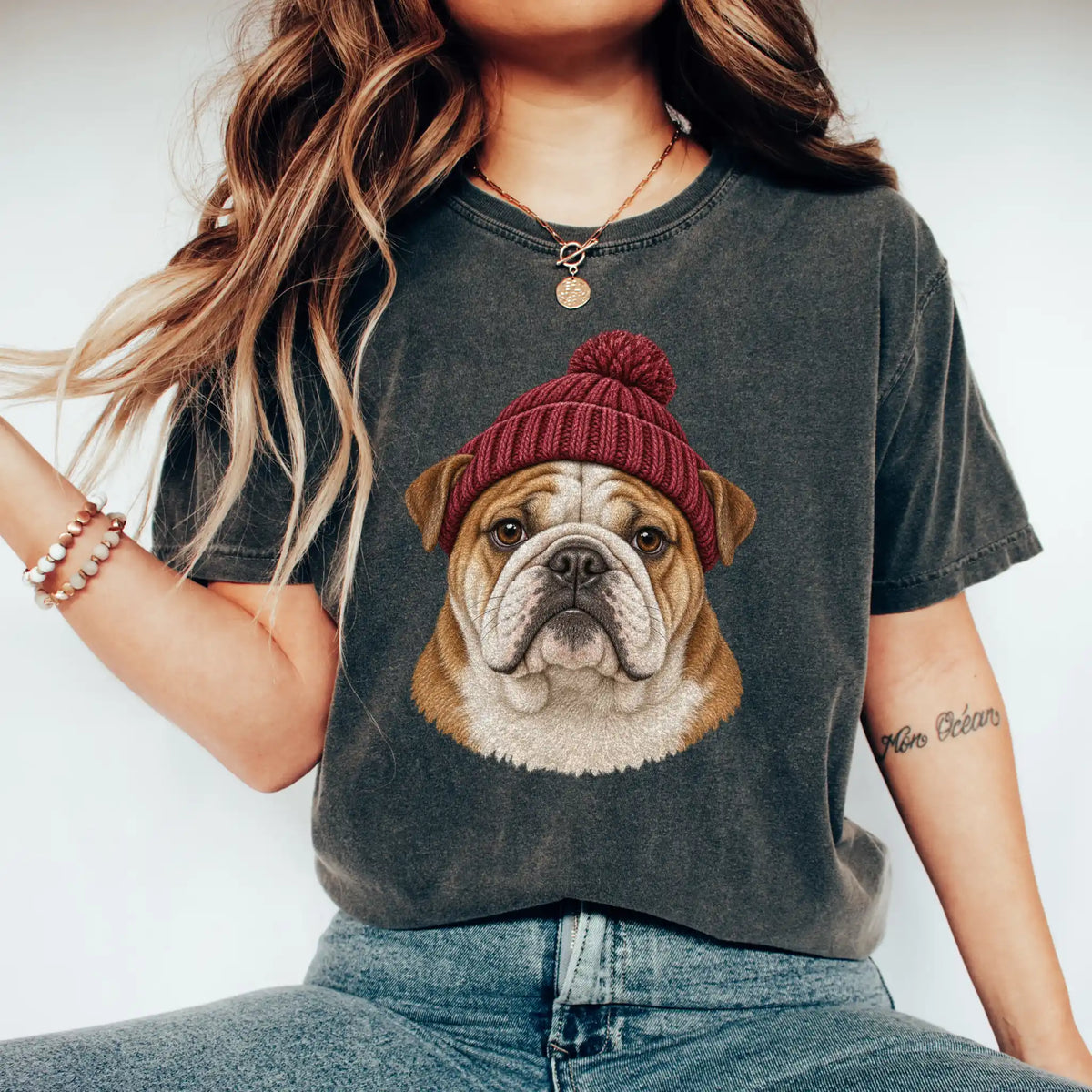 Woman wearing a Pepper Bulldog hipster T-shirt with a maroon-beanie dog portrait