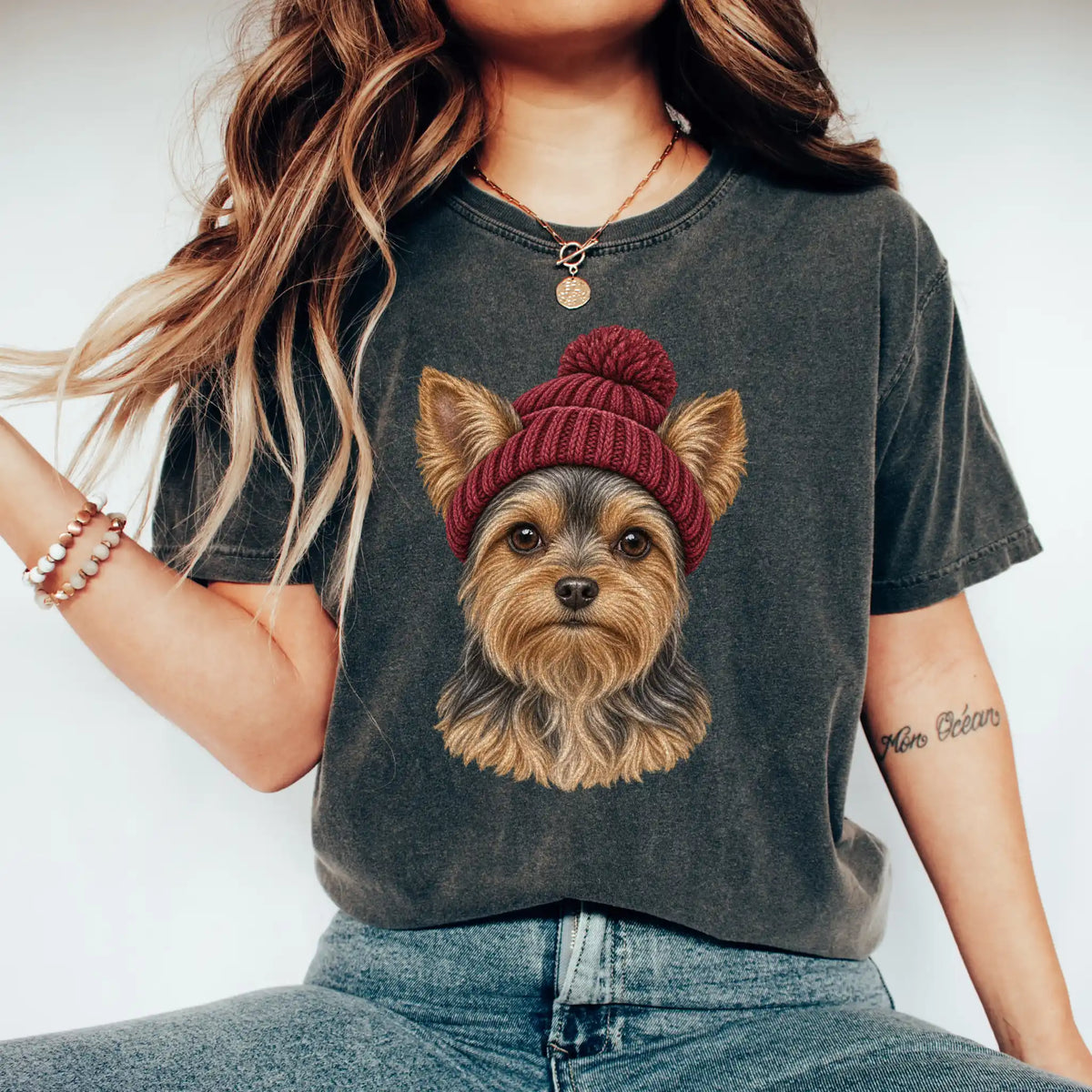 Woman wearing a Pepper Yorkie hipster T-shirt with a maroon-beanie dog portrait