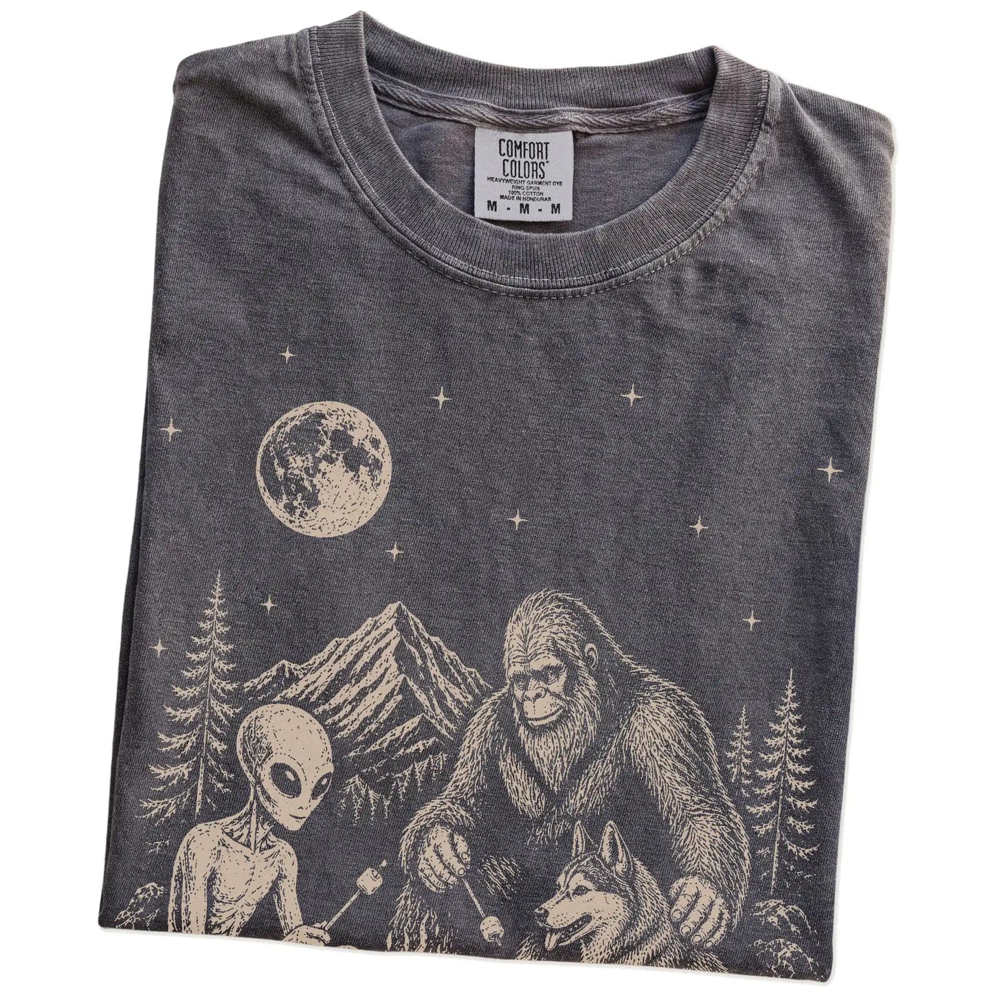 Folded Pepper Comfort Colors® T-shirt showing Husky camping with Bigfoot and an alien
