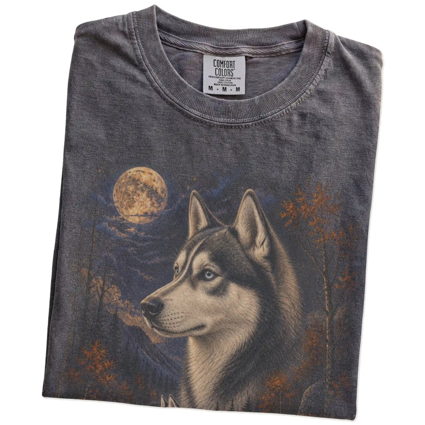 Folded Pepper Comfort Colors® t-shirt showing Husky in a fall forest graphic
