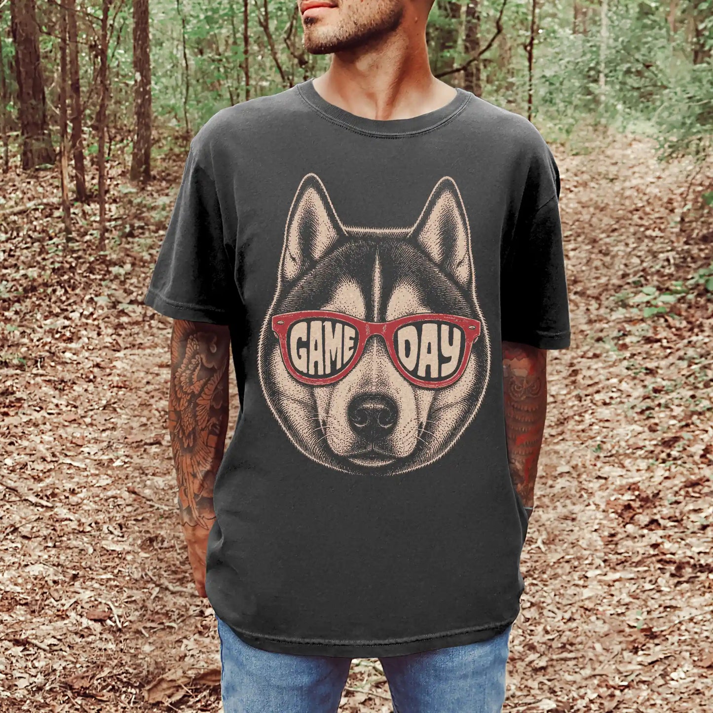 Model wearing a Pepper Comfort Colors® T-shirt with husky wearing red game day sunglasses