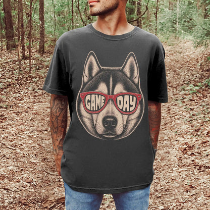 Model wearing a Pepper Comfort Colors® T-shirt with husky wearing red game day sunglasses
