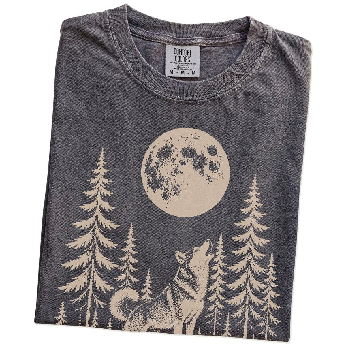 Folded Pepper Comfort Colors® T-shirt showing a Husky howling beneath the moon and pine trees