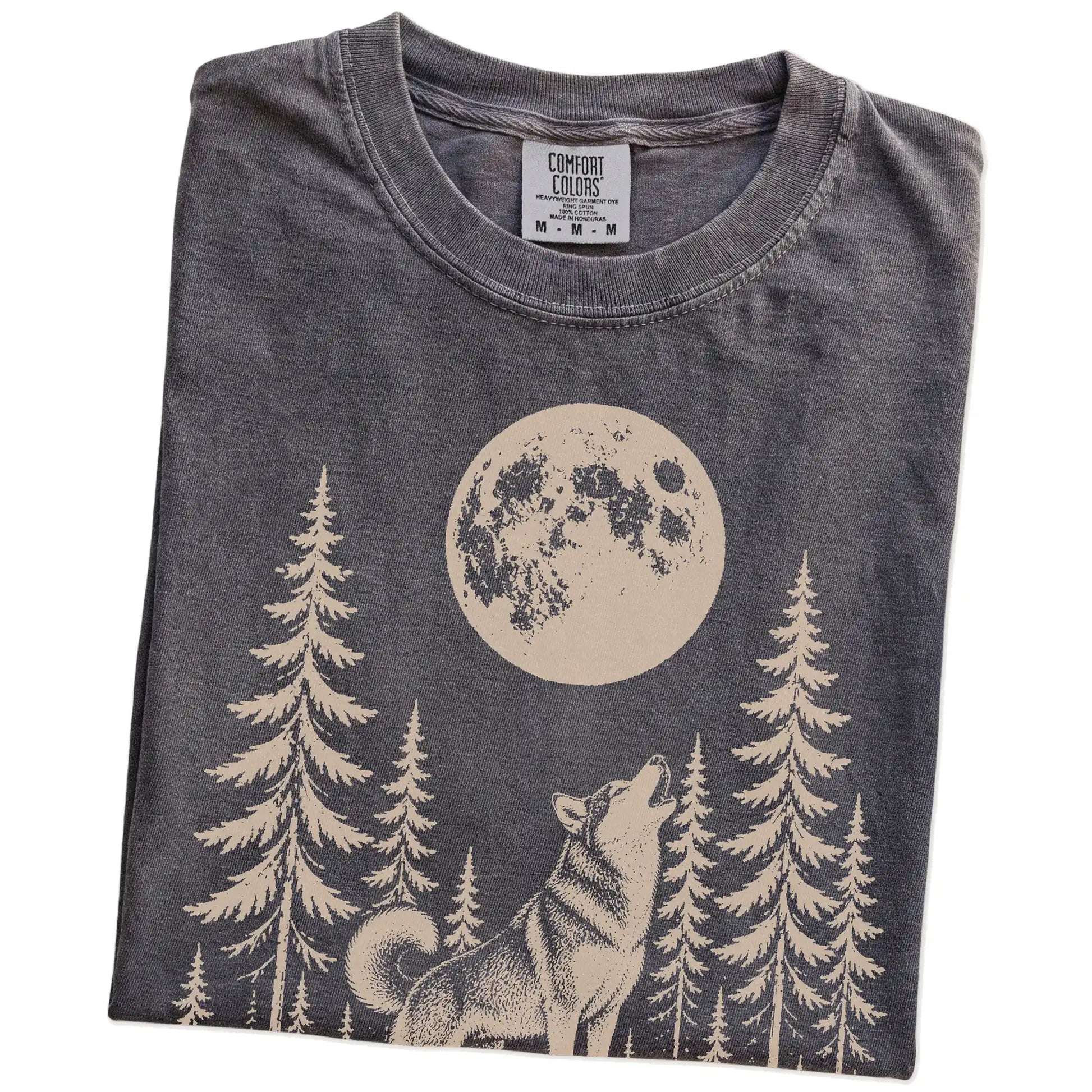 Folded Pepper Comfort Colors® T-shirt showing a Husky howling beneath the moon and pine trees