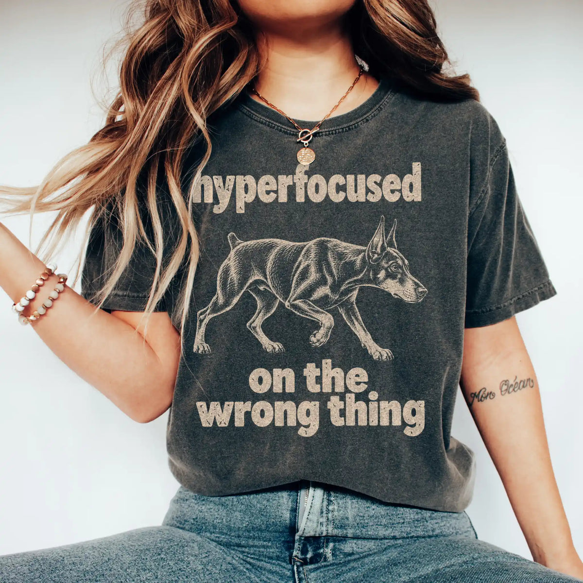 Person wearing a Pepper T-shirt with Doberman “hyperfocused on the wrong thing” design