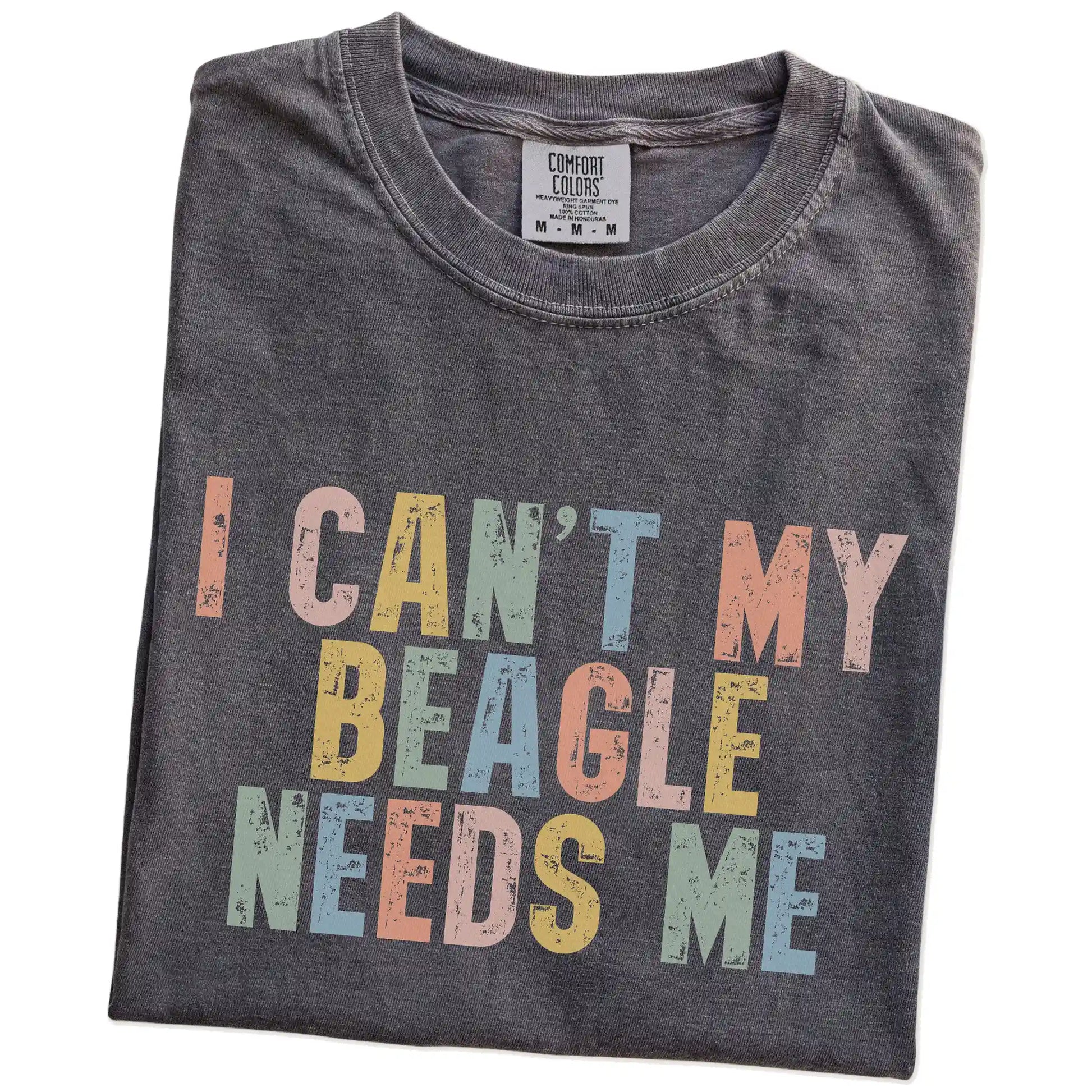 Folded Pepper Comfort Colors® T-shirt showing Beagle with “I Can’t, My Dog Needs Me” lettering