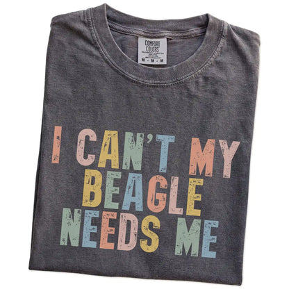 Folded Pepper Comfort Colors® T-shirt showing Beagle with “I Can’t, My Dog Needs Me” lettering