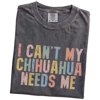 Folded Pepper Comfort Colors® T-shirt showing Chihuahua with “I Can’t, My Dog Needs Me” lettering