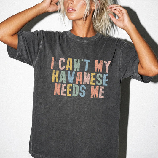 Model wearing a Pepper Comfort Colors® T-shirt featuring Havanese with “I Can’t, My Dog Needs Me” lettering