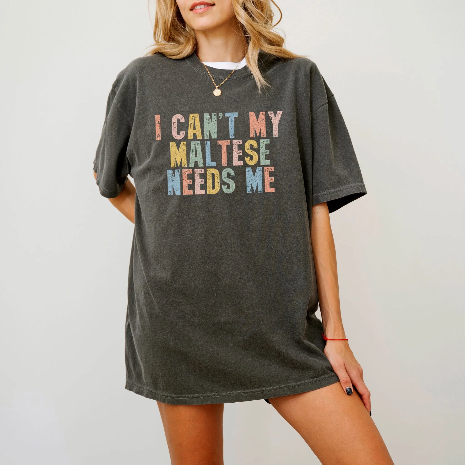 Model wearing a Pepper Comfort Colors® T-shirt featuring Maltese with “I Can’t, My Dog Needs Me” lettering