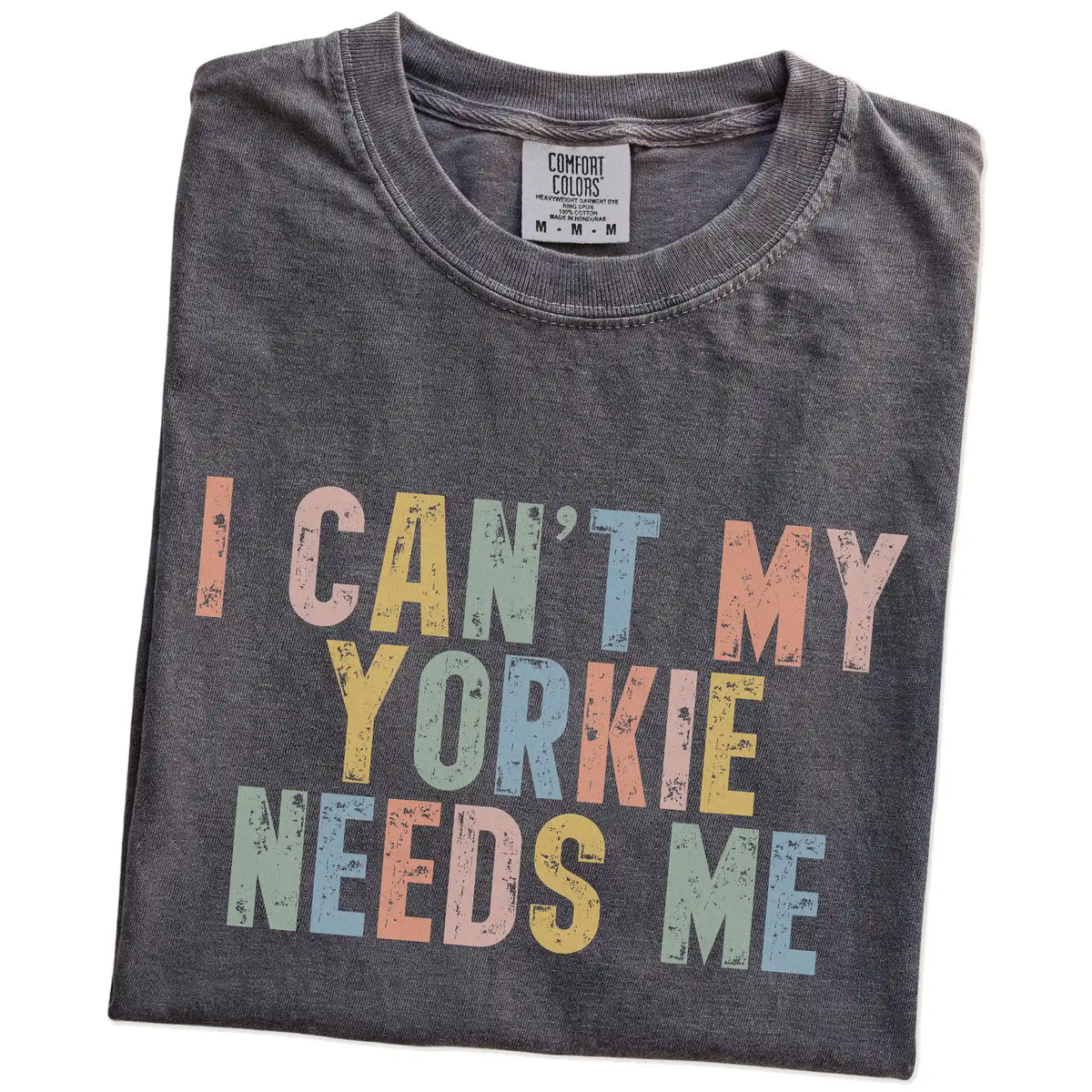 Folded Pepper Comfort Colors® T-shirt showing Yorkie with “I Can’t, My Dog Needs Me” lettering