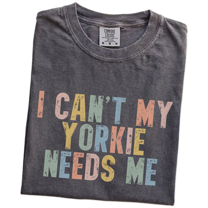 Folded Pepper Comfort Colors® T-shirt showing Yorkie with “I Can’t, My Dog Needs Me” lettering