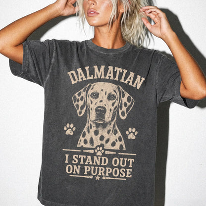 Model wearing a Pepper Comfort Colors® T-shirt featuring Dalmatian design with “I Stand Out On Purpose” lettering