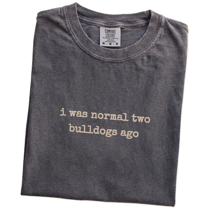 Folded Pepper Comfort Colors® T-shirt showing i was normal two bulldogs ago lettering
