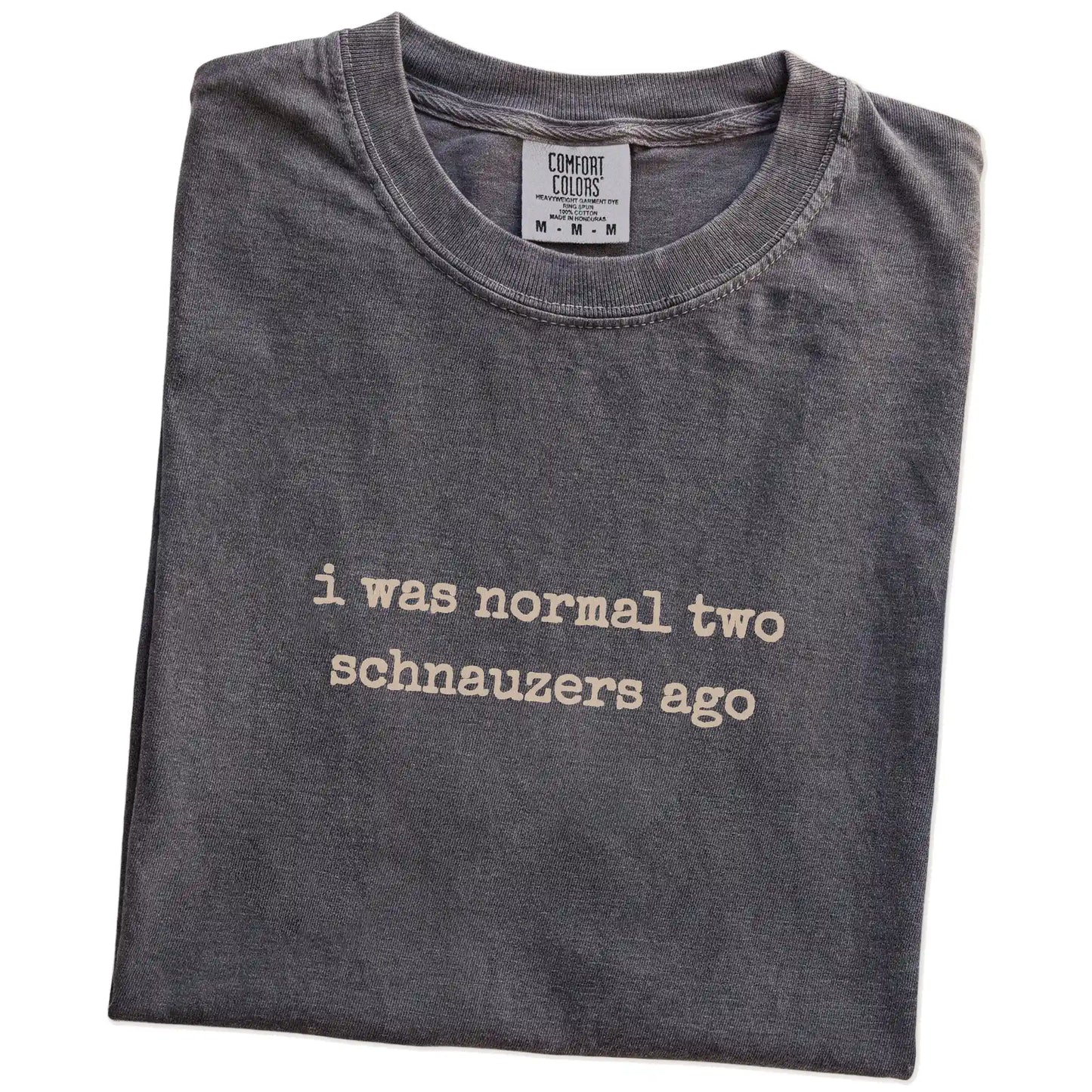 Folded Pepper Comfort Colors® T-shirt showing i was normal two schnauzers ago lettering